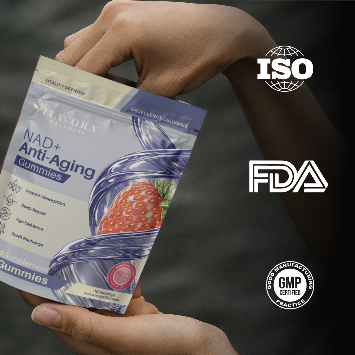 Hand holding a Vitavora Wellness NAD+ Anti-Aging Gummies pouch with strawberry infusion styling, next to ISO, FDA, and GMP Certified Good Manufacturing Practice trust badges.